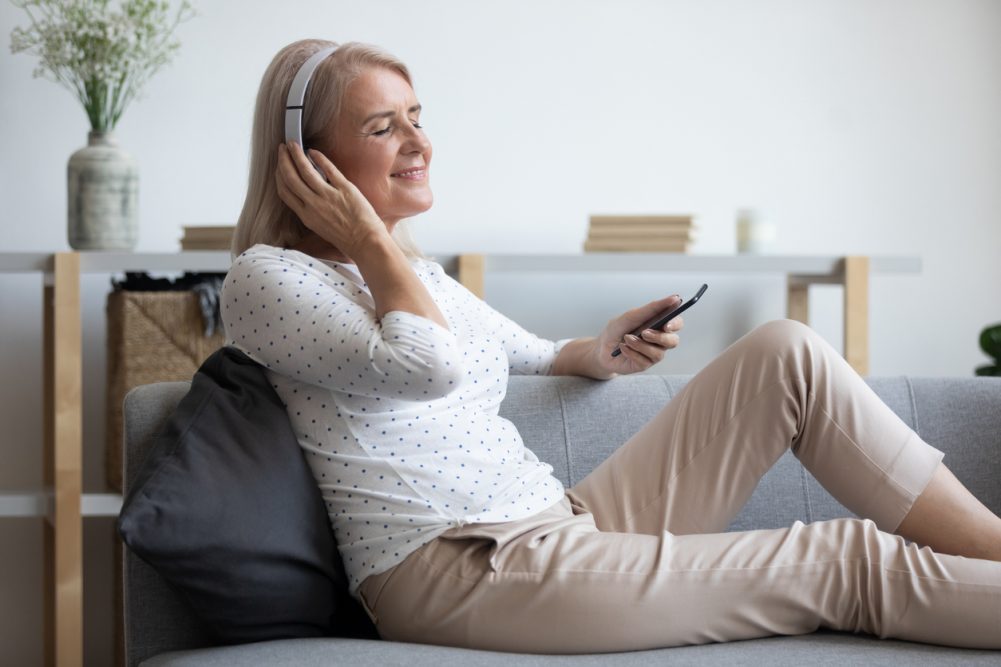 Woman happily listening to music