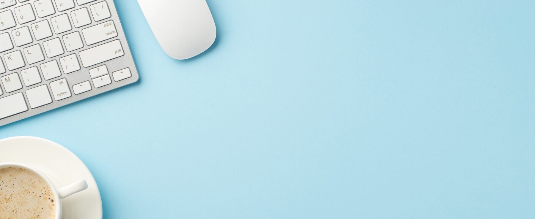 Blue desk with keyboard and coffee